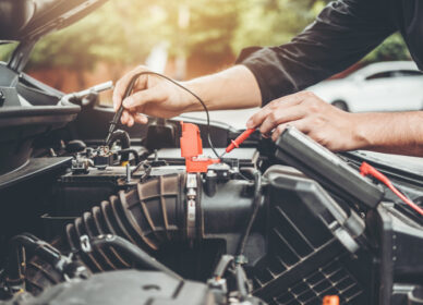 Auto mechanic working in garage Technician Hands of car mechanic working in auto repair Service and Maintenance car battery check.