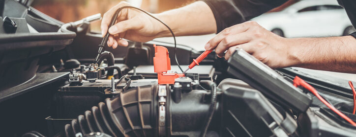 Auto mechanic working in garage Technician Hands of car mechanic working in auto repair Service and Maintenance car battery check.